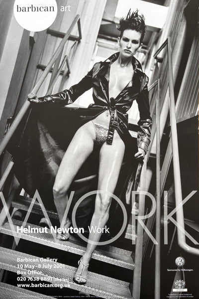 A black and white art poster for Helmut Newton's 'Work' exhibition at Barbican Gallery, featuring a dramatic fashion photograph of a model in a glossy leather jacket and shorts on metal stairs.